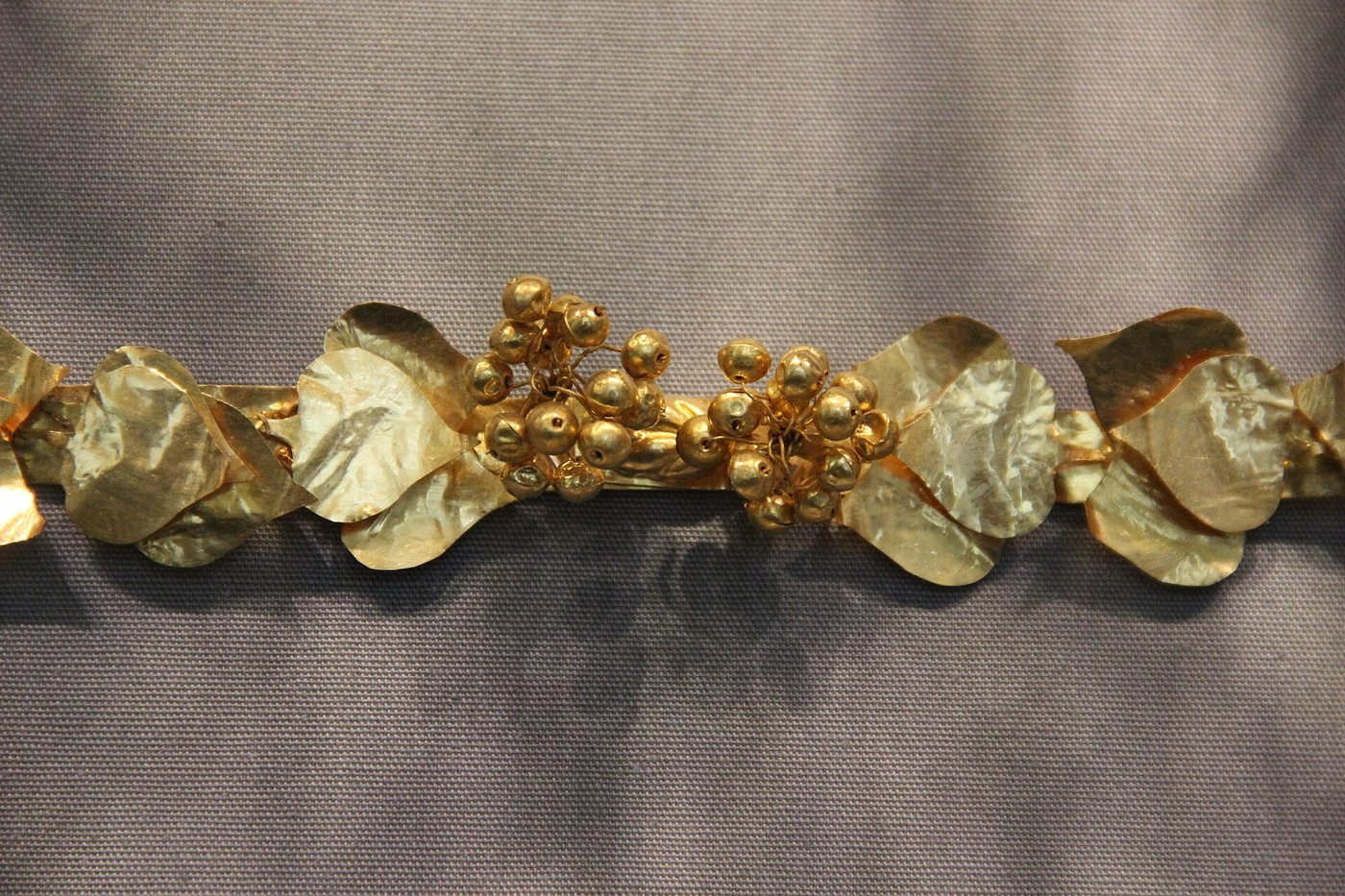 Macro di una corona d'oro antica a foglie e bacche: il vero oro artigianale che M&L valuta